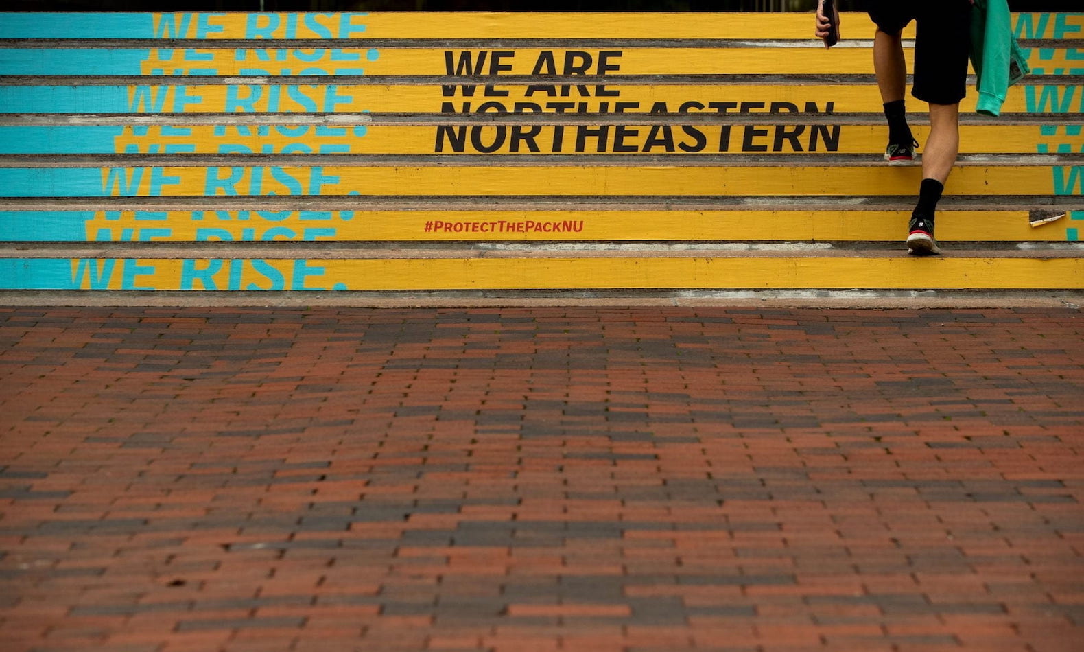 Steps on the Northeastern campus with text: "Rise. We are Northeastern."